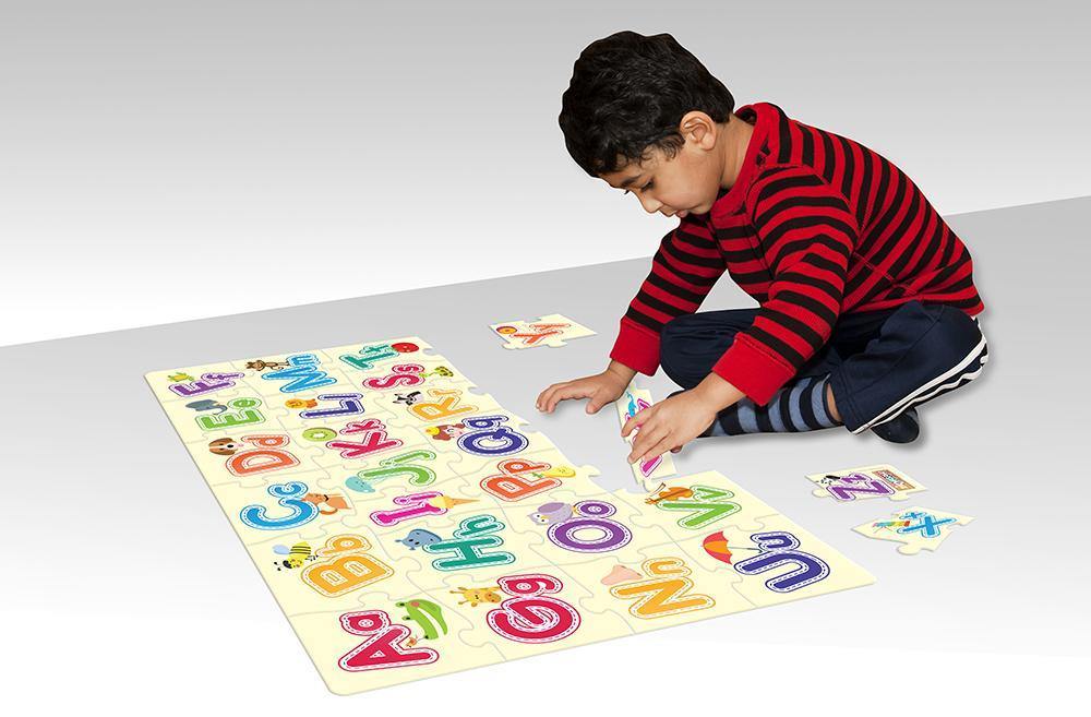 kid playing with alphabet puzzle